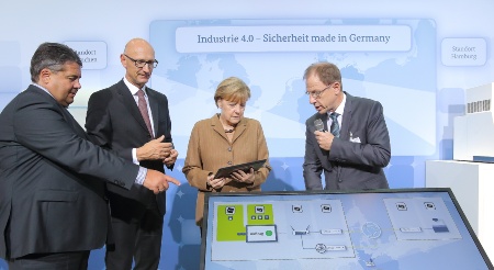 Infineon Technologies AG and Deutsche Telekom AG today presented a security solution for the protection of networked production on occasion of the "Nationaler IT-Gipfel 2014" in Hamburg. From left to right: Sigmar Gabriel, Federal Minister for Economic Affairs and Energy, Timotheus Höttges , CEO Deutsche Telekom, Federal Chancellor Angela Merkel, Reinhard Ploss, CEO Infineon Technologies.